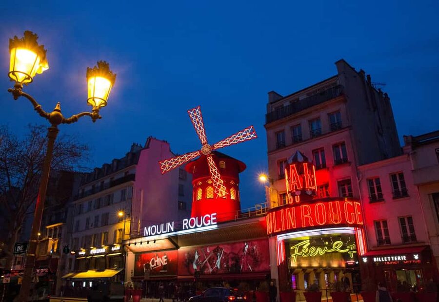 Paris: Champagne at the Moulin Rouge & Seine River Cruise - Féerie at the Moulin Rouge: Champagne, Big Costumes, and Can-Can Fire