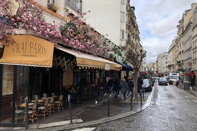 Paris Montmartre Private Walking Tour - Best Art, Culture, Food - The surreal nod: a man walking through a wall