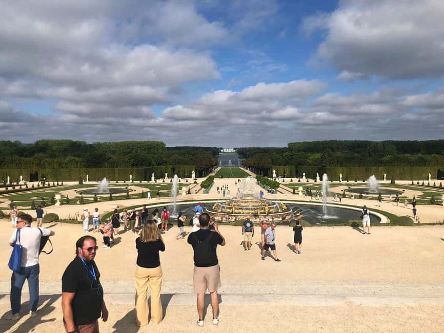 Versailles: Palace & Gardens Guided Tour with Entry Tickets - The meeting point near the Louis XIV statue